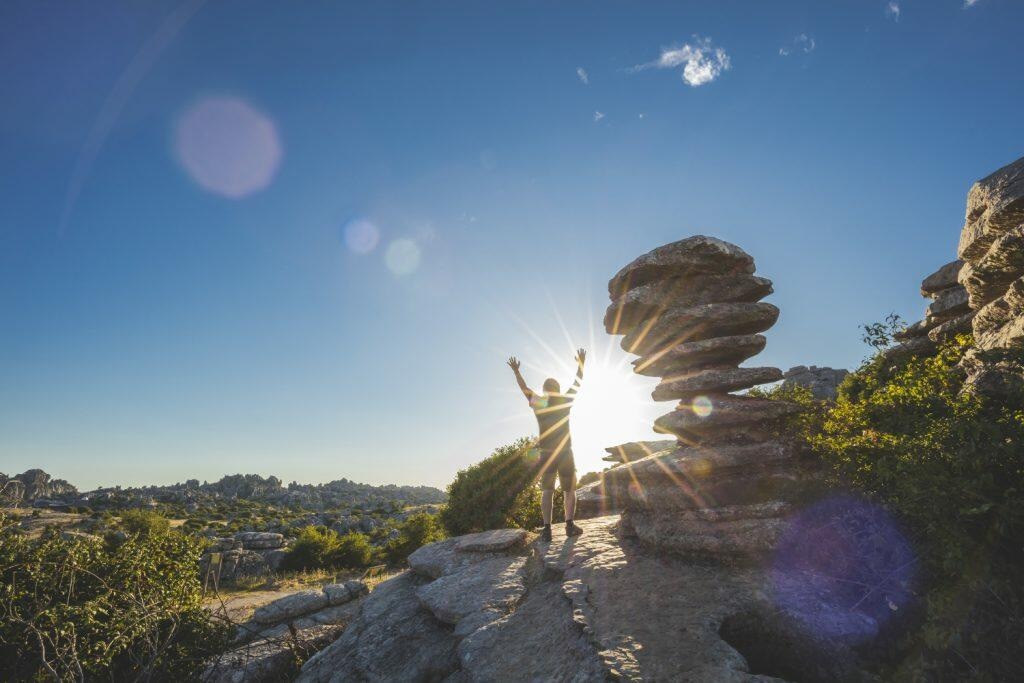 Adventurous man standing on a mountain - Maui Recovery