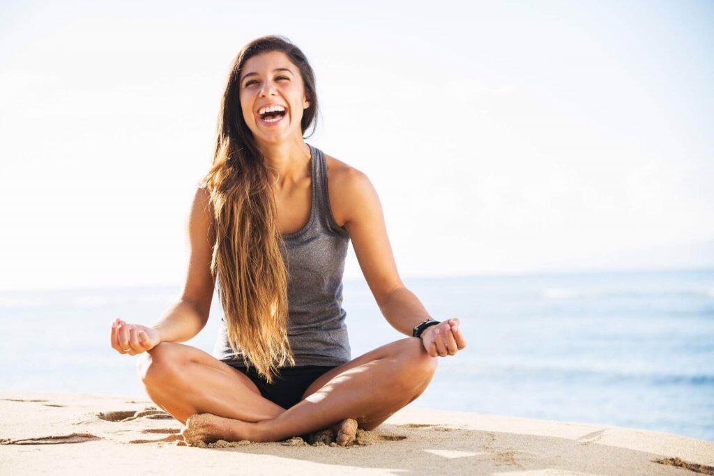 smiling woman by the beach meditation concept - Maui Recovery