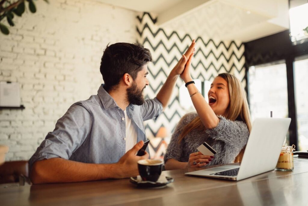 Front view of an excited couple buying online
