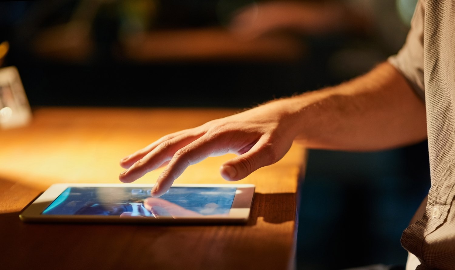 I have all I need at my fingertips. Cropped shot of a man using his digital tablet