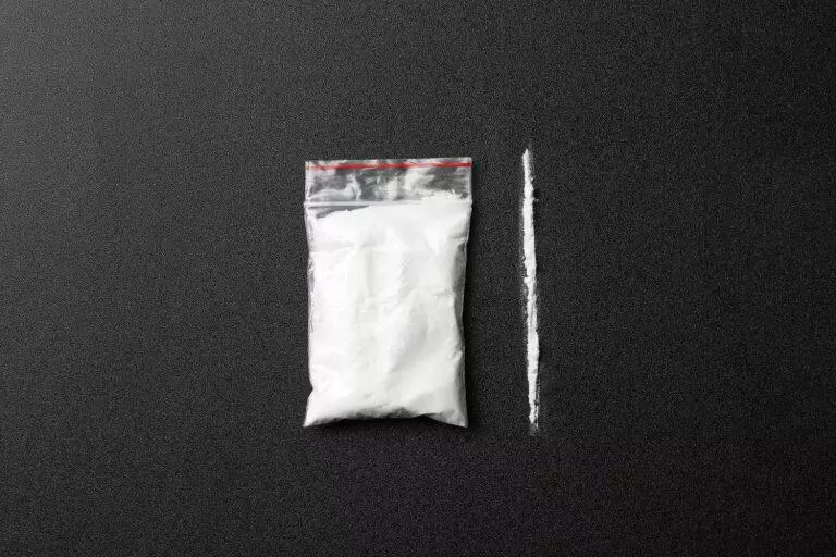 Flat lay composition with cocaine on dark background - Maui Recovery