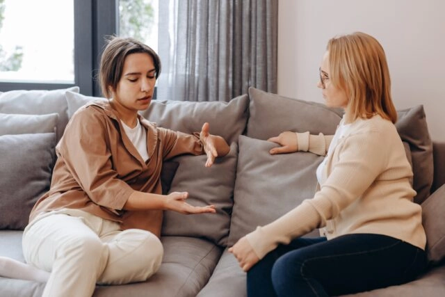 Individualised Treatment Program. Woman in Therapy A young woman in a consultation with a professional psychologist listens to advice on improving behavior in life. The modern millennial woman is developing mindfulness and psychological health
