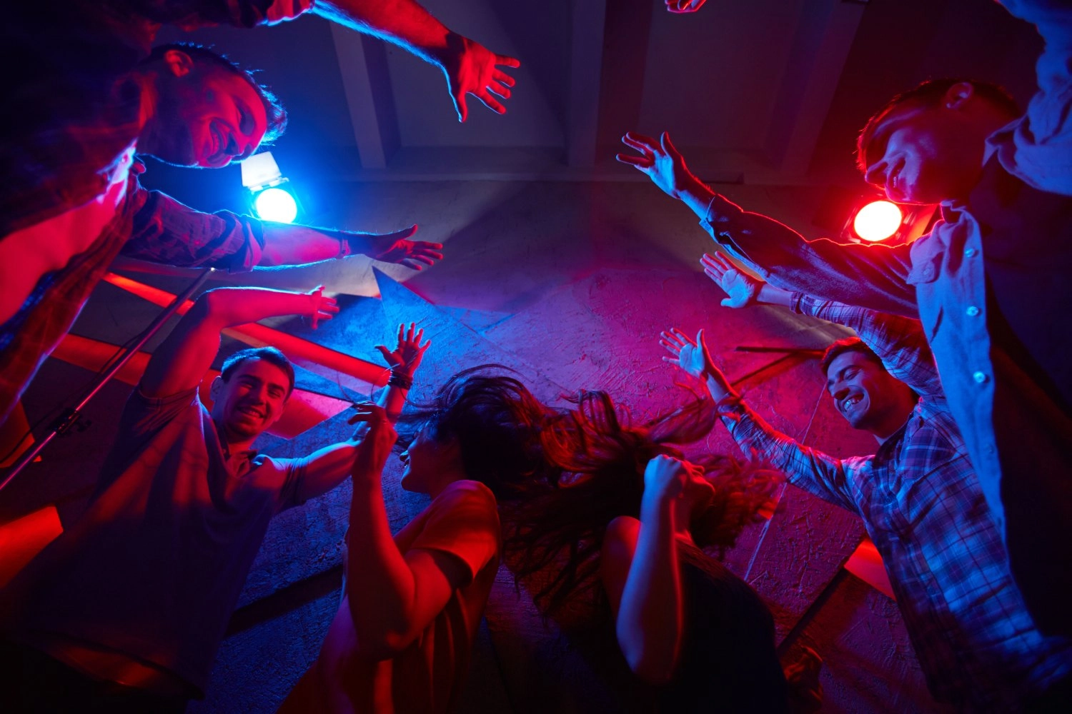 Carefree guys and girls having party in night club