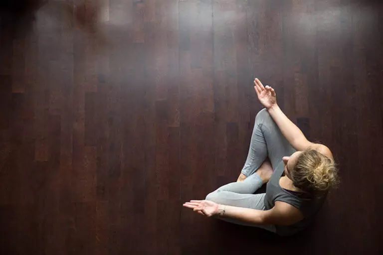 A person practices meditation in recovery.