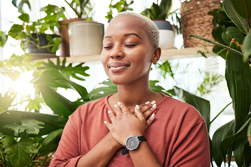 A woman practices a deep breathing exercise to enhance relaxation.